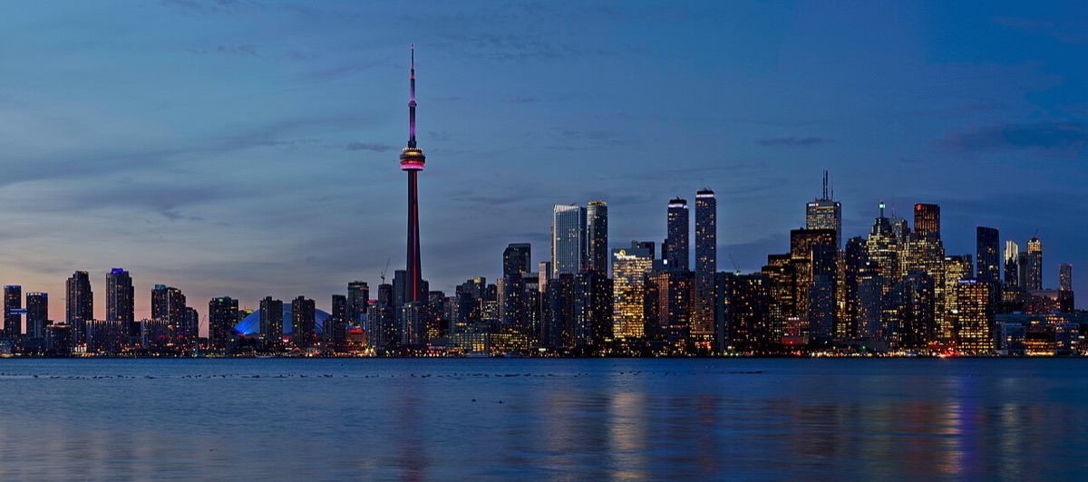 The downtown Toronto skyline and CN Tower at dusk, seen across the water from the Toronto Islands.